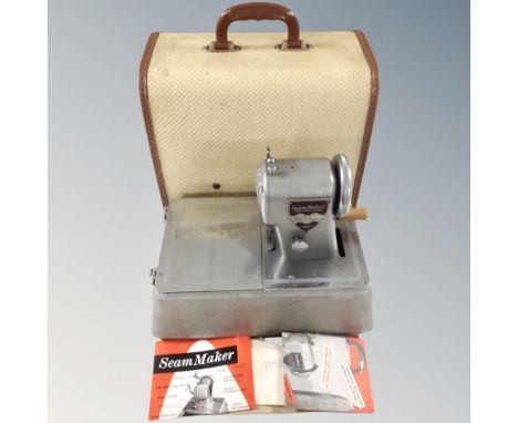 A vintage Seam Maker model SM9 sewing machine with original booklets in case. 
