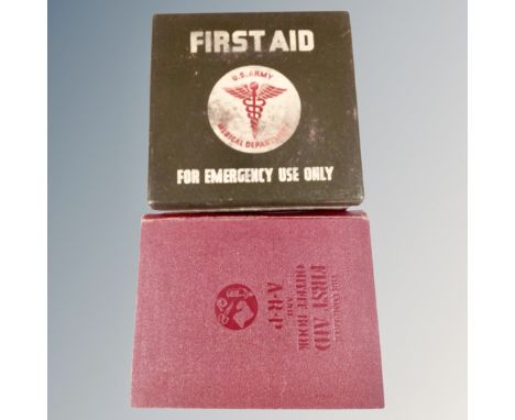 A 20th century US Army first aid kit in metal case together with the complete first aid outfit book