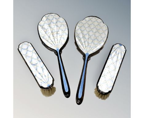 A superb four piece white, blue and gold enamel silver dressing table set