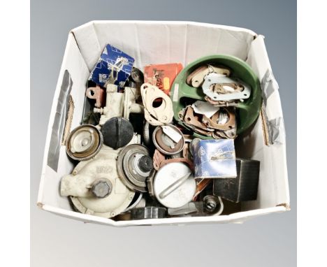 A box of vintage car parts including petrol caps 