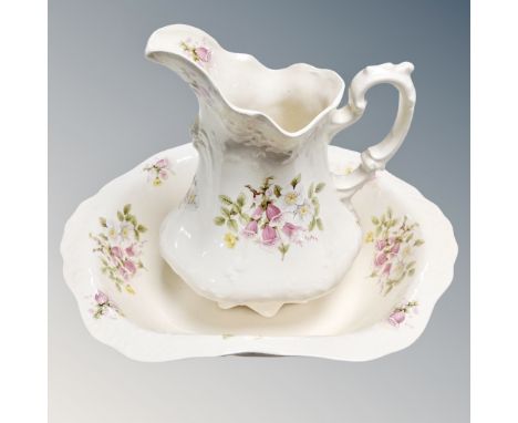 A cream floral wash jug and basin together with further twin handled foot bath 
