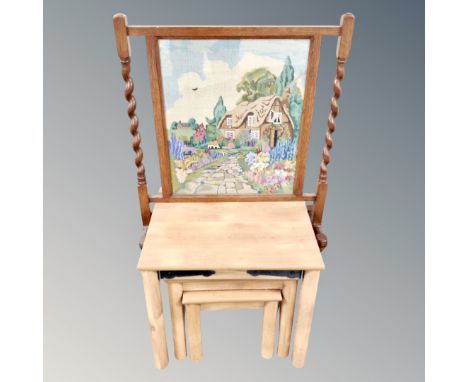 A nest of three pine effect tables together with an oak barleytwist firescreen 
