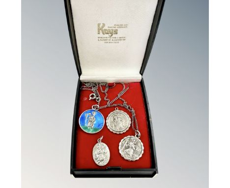 Four silver St Christopher pendants including an enamel example 