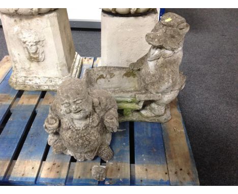 A concrete planter modelled as a badger with wheel barrow together with further concrete ornament Buddha (af)