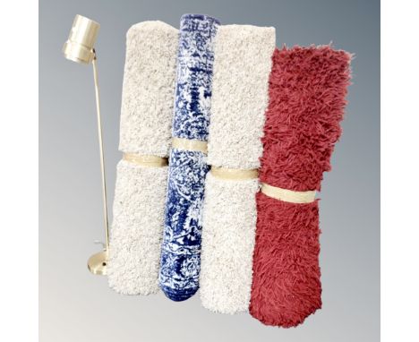 An anglepoise floor lamp together with four modern woolen rugs 