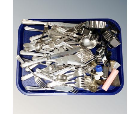 A tray of set of Insignia plated cutlery, cookie cutters, vintage cake nozzles 