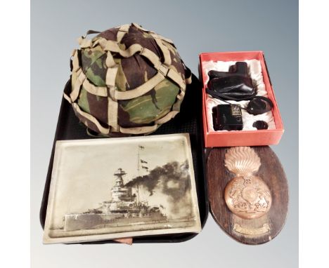 An army helmet, Royal Scots Fusilier's plaque on board, metal panel depicting a battle ship, boxed Pentax camera kit 