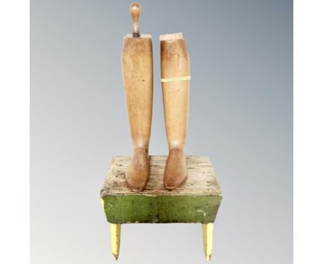 A pair of vintage wooden boot stretchers together with a cracket 
