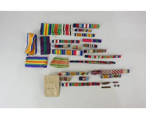 A collection of First and Second World War ribbons, bars, oak leaves, and roses, to include a 5th Aug - 22nd Nov 1914 bar