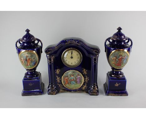 A Victorian Empire ware porcelain clock garniture depicting three classical women dancing, playing music and carrying fruit a