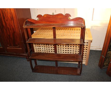 A Victorian mahogany hanging wall shelf of waterfall form 77.5cm wide