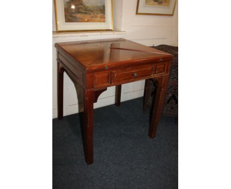 An Edwardian style mahogany envelope games table, with fold out swivel top enclosing green baize with removable centre panel 