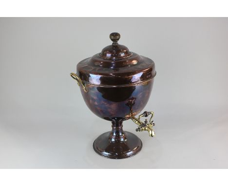 A copper samovar, with wooden finial, two brass handles and tap, on circular base, 50cm high