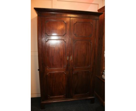 A Continental mahogany wardrobe with moulded cornice, twin panelled doors, on bracket base, 120cm