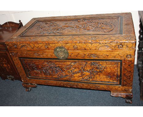 A Chinese carved camphor wood trunk with deeply carved panels of exotic birds and floral surround, 100cm