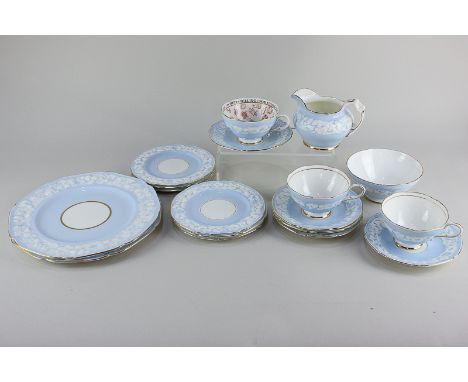 A Paragon porcelain fortune telling cup and saucer, together with a Paragon part tea service with floral decoration on pale b