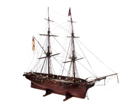 A 19th century scale model of a 16 gun sixth rate sloop: standing rigged and flying a white ensign and Union Jack over deck w