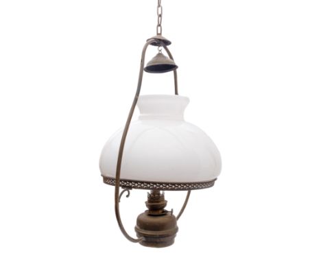 A brass ship's hanging oil lamp: the inverted baluster frame  with white glass shade over copper burner, 58cm high