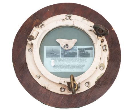 A battle damaged port hole from the Royal Navy Black Swan-class sloop HMS 'Amethyst' (U16):  the glass with small calibre Nat
