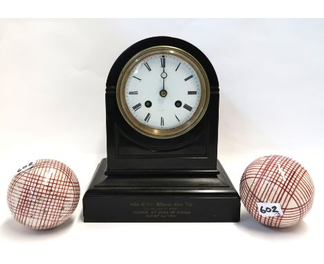 A dome top black slate mantle clock and two red and white pottery carpet bowls Condition Report: Available upon request