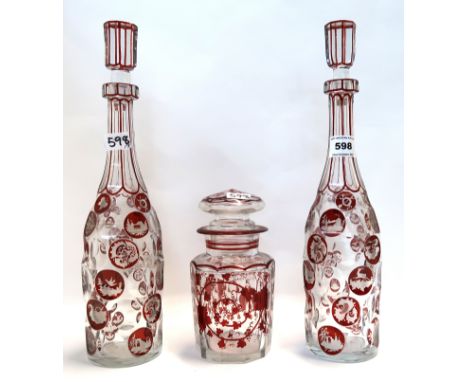 A pair of ruby flashed and cut glass decanters, together with a lidded jar Condition Report: Available upon request