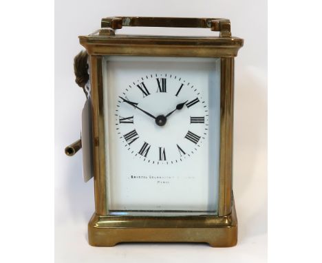 A French brass cased carriage clock Condition Report: Top panel and front panel with slight chips to glass. Has key . Name on