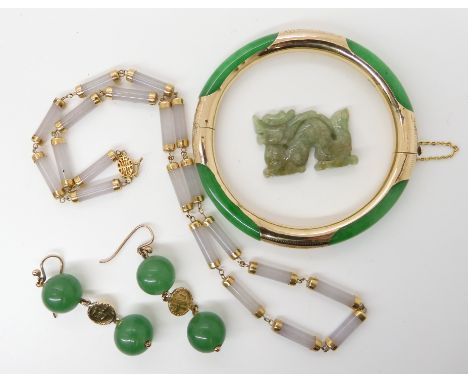 14k gold mounted Chinese green hardstone bangle, and earrings, lilac hardstone necklace and a green hardstone dragon Conditio