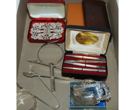 A cased set of sterling bridge pencil, white-metal belt buckle, decanter labels etc Condition Report: Available upon request