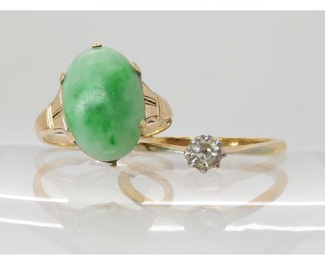 A 14k gold Chinese green hardstone ring size K, weight 3gms, together with an 18ct gold clear gem set ring size P, weight 2.2