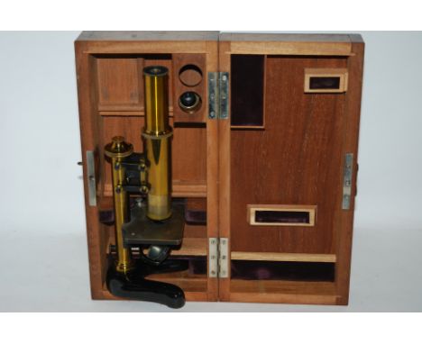A brass student microscope in fitted case and box of slides (2) Condition Report: Available upon request