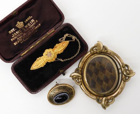 A 15ct gold brooch with a diamond set star, weight 3.4gms, a yellow metal onyx and enamel Victorian brooch and a gold plated 