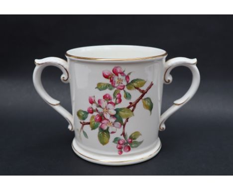 A Royal Worcester loving cup, transfer and infil decorated with flower blossoms, 13.5cm high 