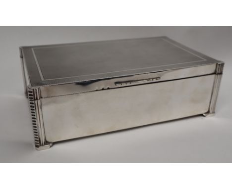 A George V silver cigar box of rectangular form,. with engine turned and line decoration, London, 1934, William Comyns &amp; 