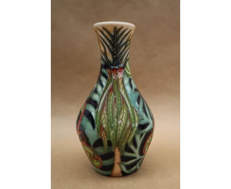 A Moorcroft pottery vase decorated with tight buds and scrolling fronds, dated 2004, 14cm high, impressed and painted marks