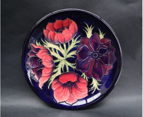 A Moorcroft pottery plate decorated in the Clematis pattern, 26cm diameter