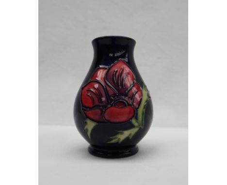 A Moorcroft pottery anemone pattern vase with a royal blue ground, impressed and painted marks, 10cm high 