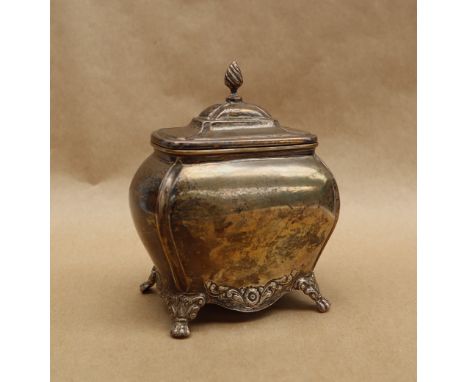 An Edward VII silver tea caddy of bombe shape, with a flame finial, the base embossed with flowerheads and leaves, with leaf 