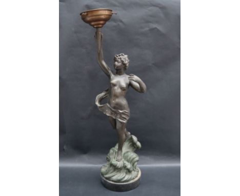 A 20th century spelter table lamp in the form of a semi naked female rising from the waves holding a lamp aloft, signed Huppe