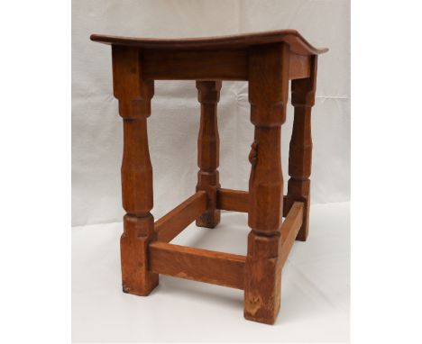 A Mouseman oak joint Stool by Robert 'MOUSEMAN' Thompson (1876-1955), with an oak dished top, on faceted baluster legs united