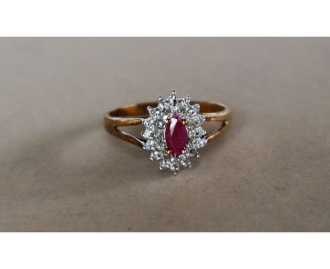 A 9ct yellow gold ruby and diamond cluster ring, set with an oval faceted ruby and two tiers of round brilliant cut diamonds 