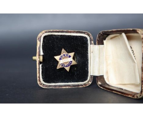 An 18ct gold long service tie stud for the Anglo-American Oil Co set with diamonds to two points of the six pointed star, ena