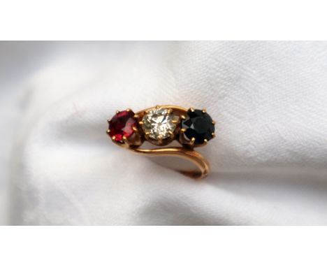 Am 18ct yellow gold three stone ring set with a round old cut diamond approximately 0.75cts, flanked by a similar sized sapph