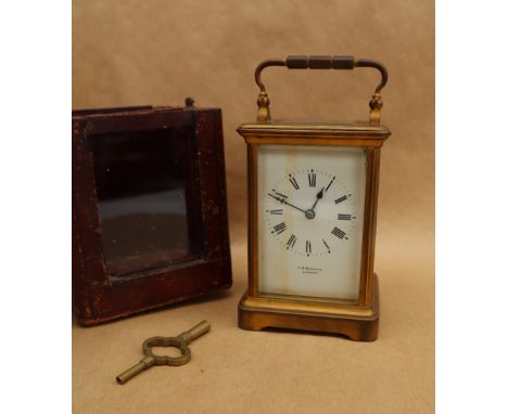 A French brass carriage clock, with a white enamel rectangular dial and Roman numerals inscribed J.W. Benson, striking on a g