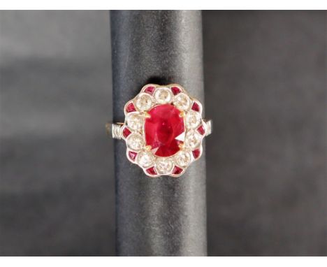 A ruby and diamond ring, the central oval faceted ruby approximately 9mm x 7mm surrounded by round brilliant cut diamonds and