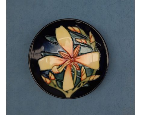 A Moorcroft pottery pin tray, decorated in the Panache pattern, dated 2004, impressed and painted marks, 12cm diameter