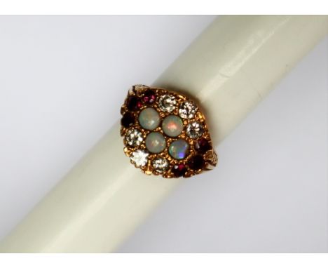 An 18ct yellow gold opal, diamond and ruby ring, set with four round cabochon opals, size round faceted rubies and six round 