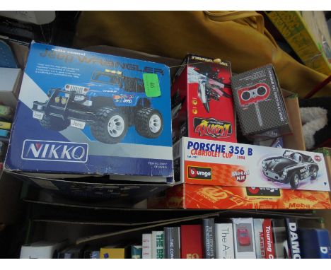 Box containing a number of originally boxed remote control cars, one by Nikko Burago and small remote control model Ferrari, 