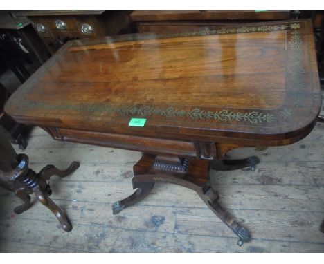 Superb flip top Regency card table in rosewood, highly decorated with inset brass on attractive brass castors