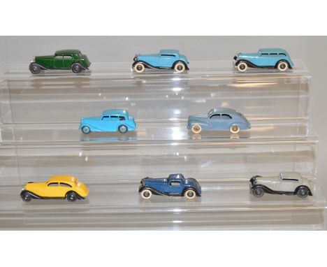 7 unboxed Dinky Toys including 36c Humber and 40b Triumph together with a French Dinky Peugeot 203, also unboxed. Models have