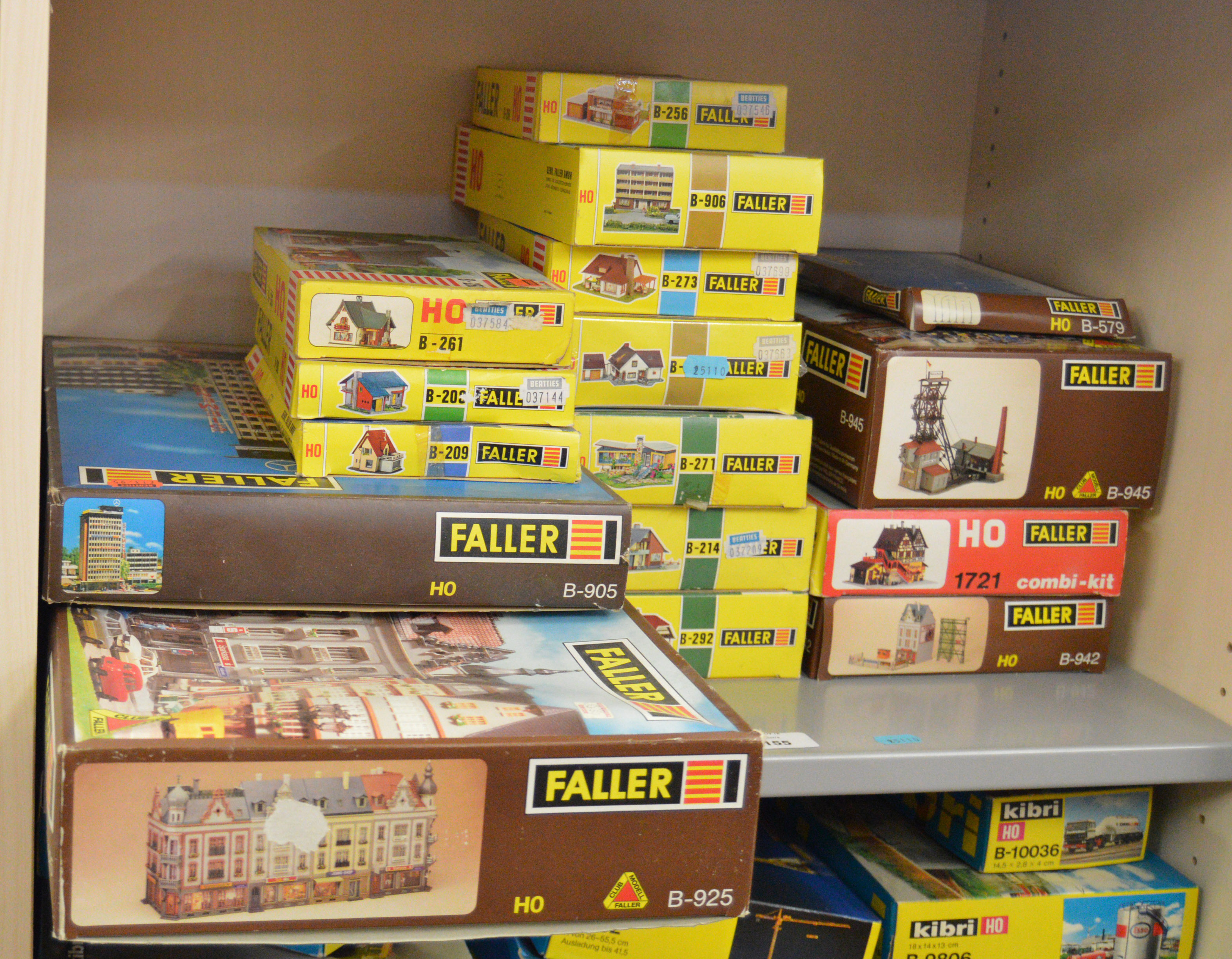 16 boxed Faller model kits in HO scale, including B925 Four Shops with
